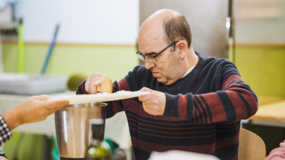 A man with learning disability baking in a kitchen.