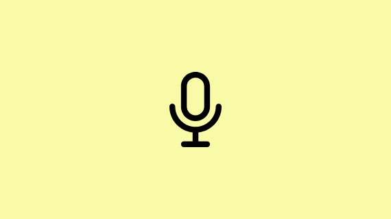 An icon of a microphone on a pale green coloured background.