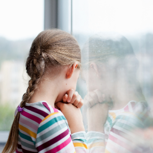 Young girl looking out of a wondow