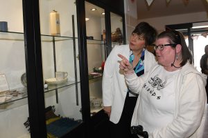 Two people look at a display of craft items