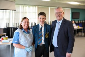 A nurse, a school pupil and the Health Minister standing together