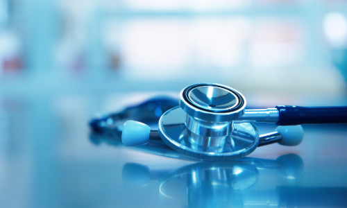 A stethoscope placed on a glass table