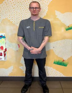 A young man wearing a McDonald's uniform.