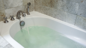 A bath filling with water