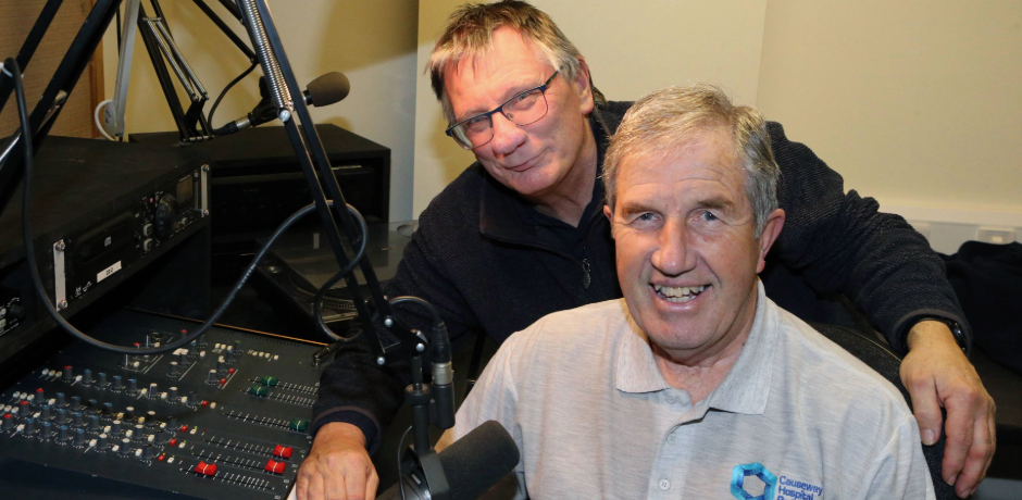 Two men in a radio studio, one with a t-shirt saying Causeway Hospital Radio