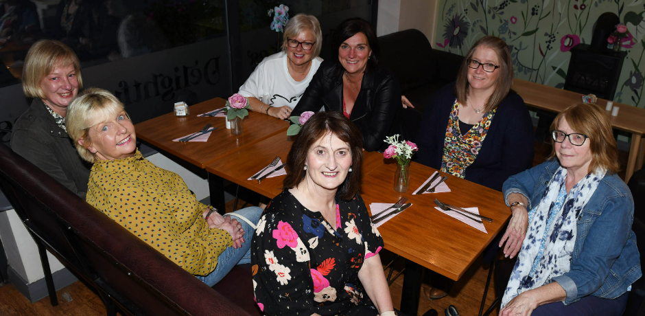 A group of women sitting together at a table.