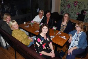 A group of women sitting around a table