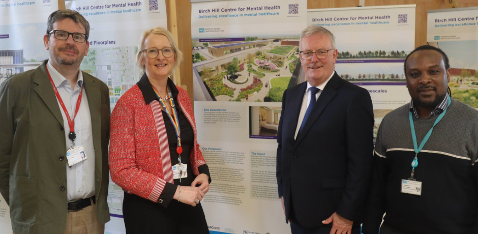 Health Minister Mike Nesbitt standing beside two males and a female, in front of architect plans for Birch Hill centre for Mental Health