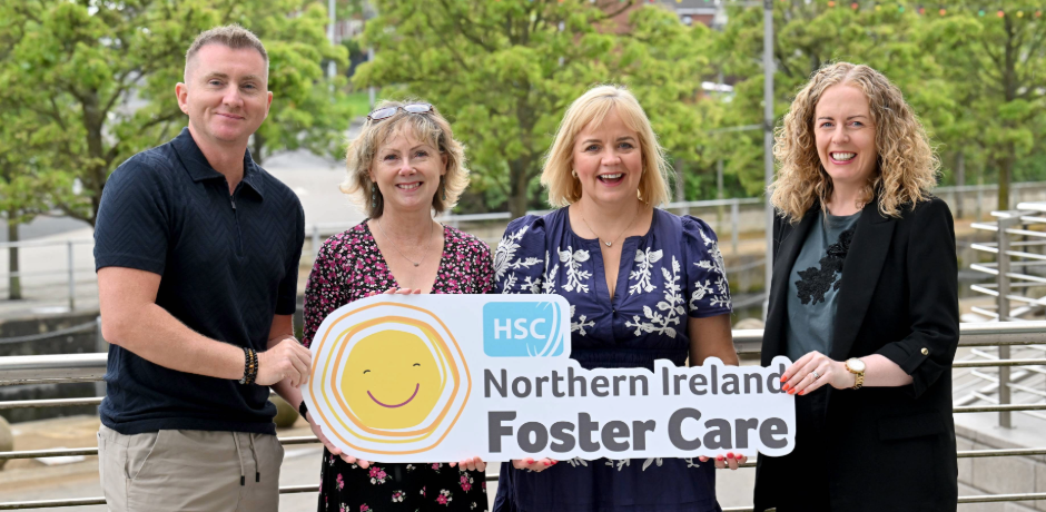 One male and three females holding a sign saying HSC Northern Ireland Foster Care