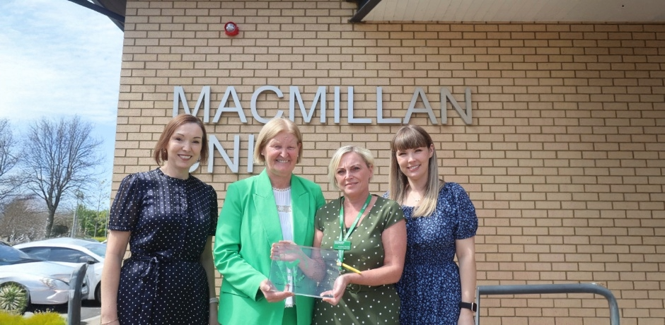 Staff holding award trophy