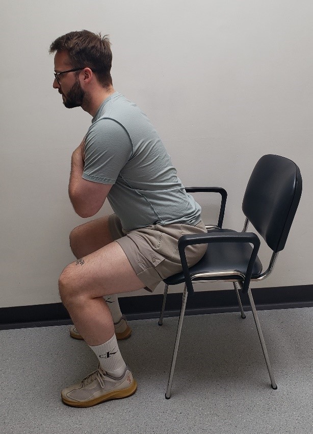 Person Demonstrating A Sit To Stand Or Squat Exercise