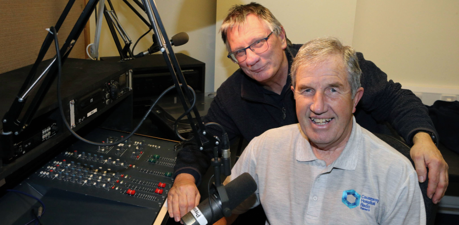 Two men sitting in a radio studio.