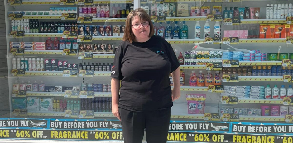 A woman stands outside a Savers shop