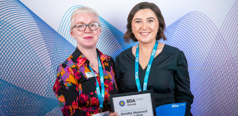 Photograph of Shelley Hannon and Gillian Farren holding an award