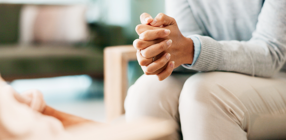 Woman sitting with her hands crossed