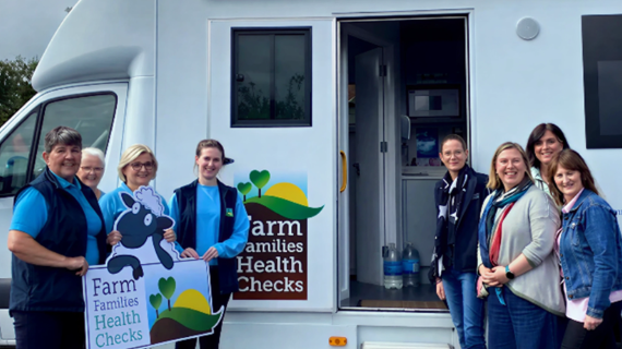 Farm Families Health Check Nurses standing beside Australian visiting Farm Families Nurses outside the Farm Families Health Check van.