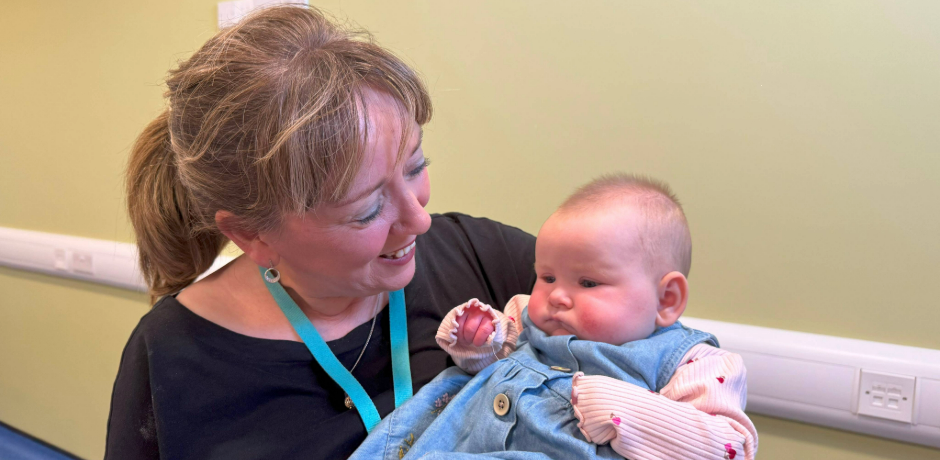 Health visitor Loretta Hegarty at baby massage group with baby Connie
