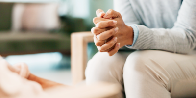 Woman sitting with her hands crossed