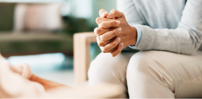 Woman sitting with her hands crossed