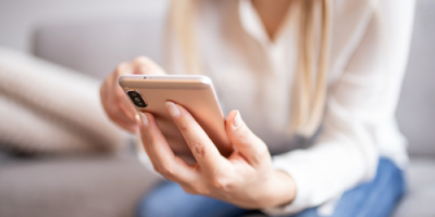 Woman holding a mobile phone.