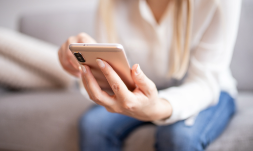 Woman holding a mobile phone.