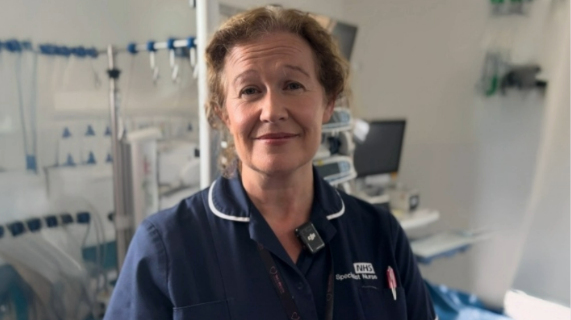 Organ donation specialist nurse Jacqueline Heasley, wearing a navy tunic while standing in a clinical environment.