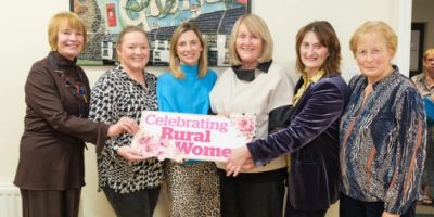 Group of women holding celebrating rural women sign.
