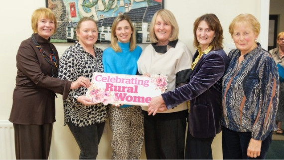 Group of women holding celebrating rural women sign.