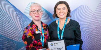 Photograph of Shelley Hannon and Gillian Farren holding an award