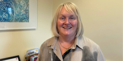 Suzanne Pullins standing in an office.