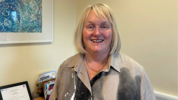 Suzanne Pullins standing in an office.