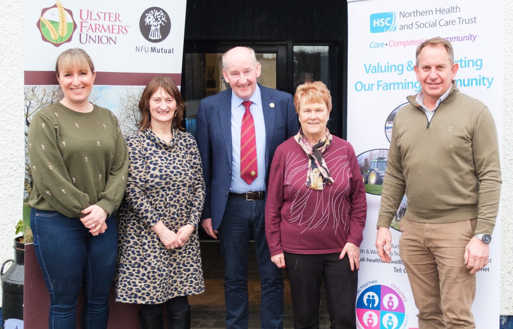 Five people standing together.