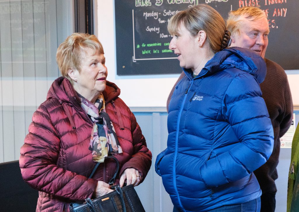 Two women talking to each other.