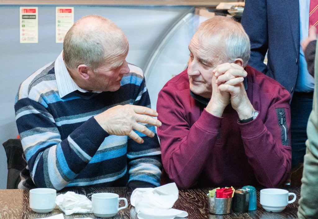 Two men talking to each other.