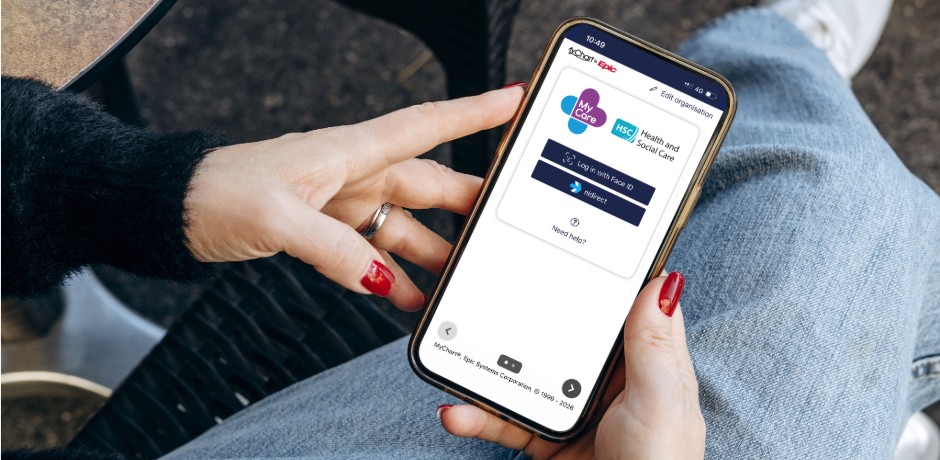 Person holding phone with My Care app on screen.