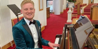 A man sits at a piano.