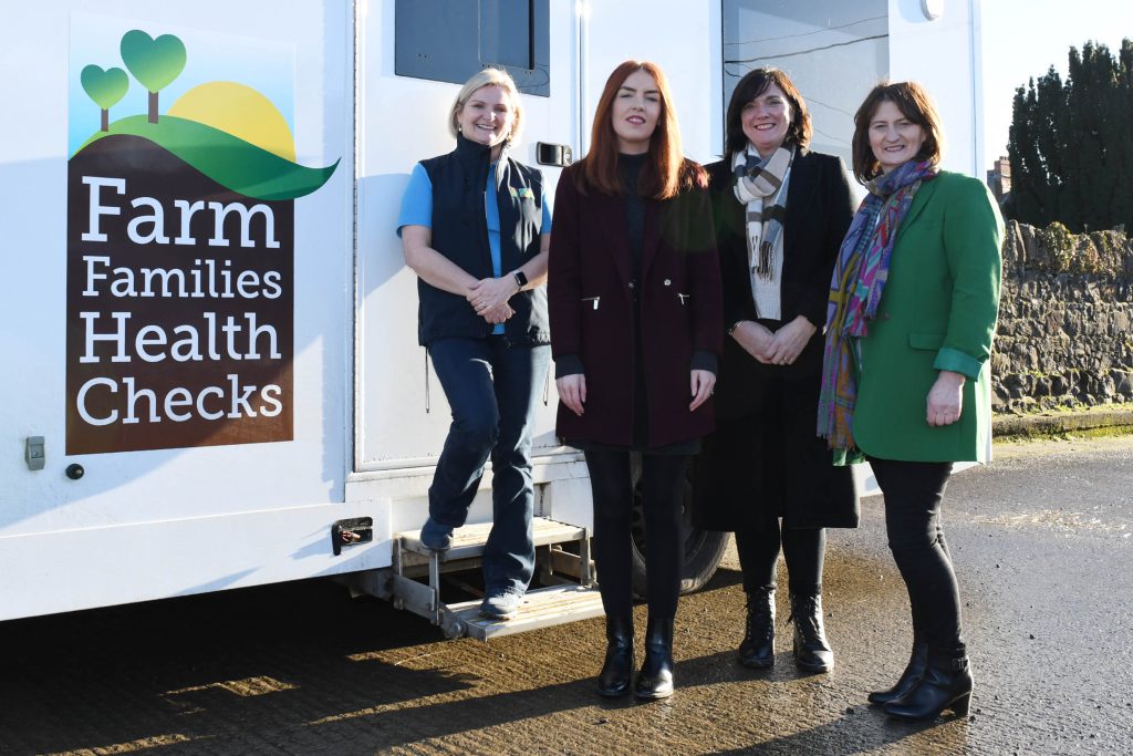 Four women standing outside the Farm Families van.