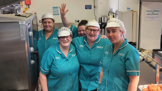 Kitchen staff smiling together.