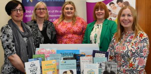 "Five women standing behind a display about books about death and bereavement."