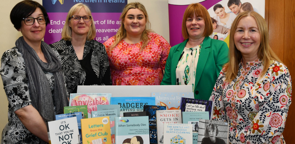Five women standing behind a display about books about death and bereavement.