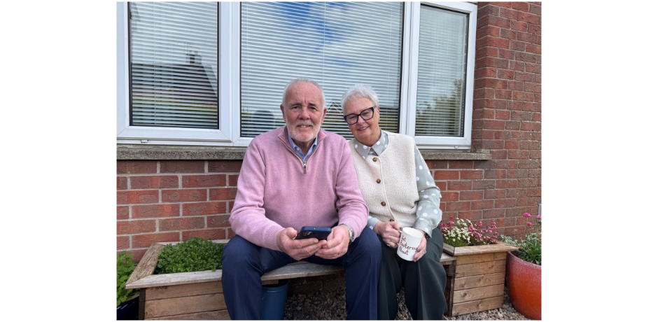 Man and woman sitting on garden seat