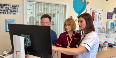 Doctor, Nurse and Dietitian standing in front of computer in Children's Ward