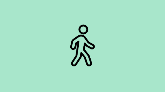 An icon on a green background visually representing a person walking.