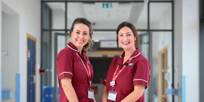 Two ladies standing together in hospital corridor