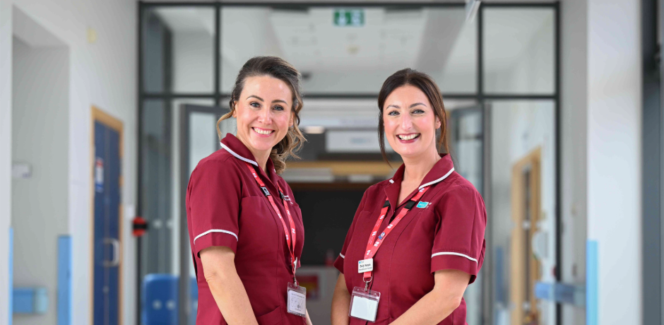 Two ladies standing together in hospital corridor