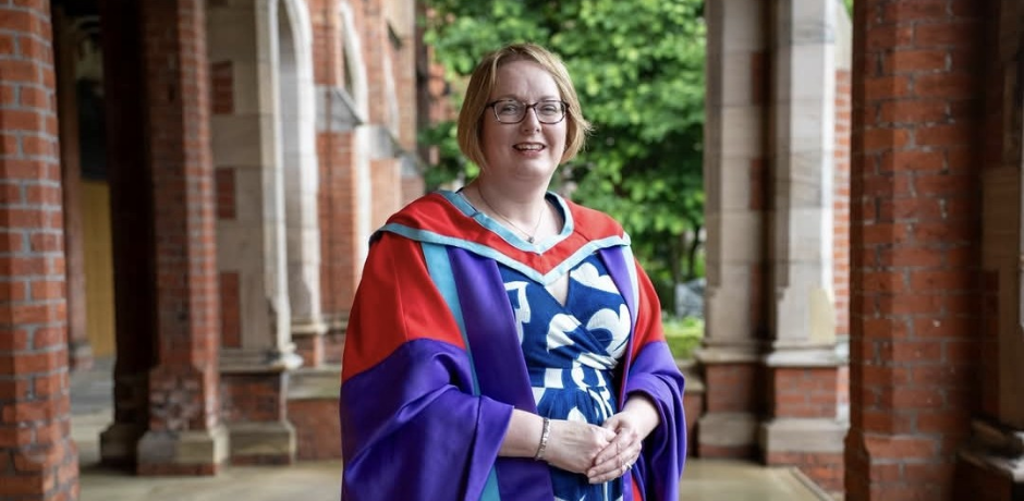 A woman wearing a graduation gown at Queen's University.