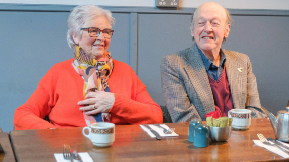 An older couple sitting in a cafe