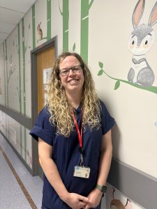 A doctor stands in a hospital corridor.