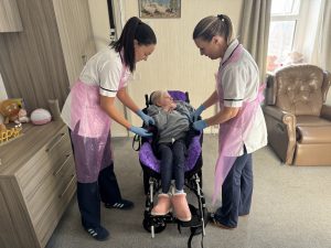 Two occupational therapists with a service user in a wheelchair