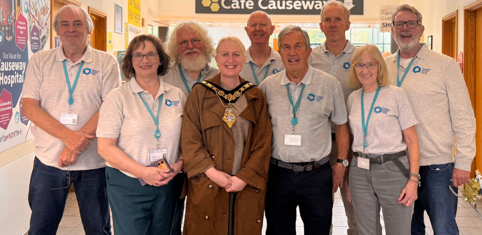 A large group of radio volunteers, standing with the Mayor of Causeway Coast and Glens Borough Council